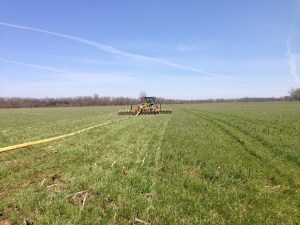 Farm machinery injecting manure in orderly rows